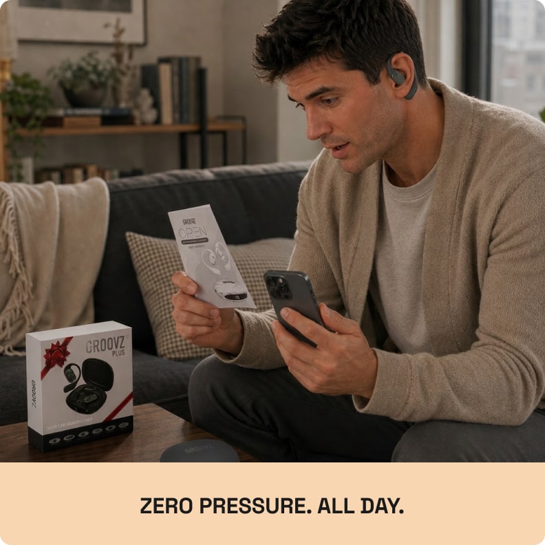 Person wearing the Groovz Plus in grey at home, unboxing beside him
